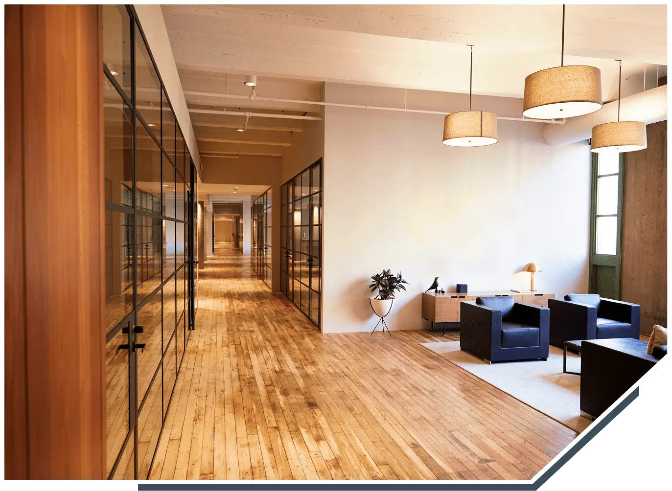 Modern office with wooden flooring and seating.